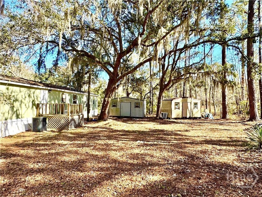 Sitting on a full acre with beautiful mature oaks, this home - photo 8