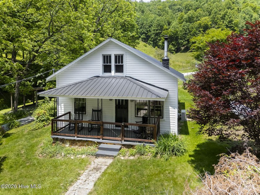 Discover a rare opportunity to own a charming 1940s mountain - photo 12