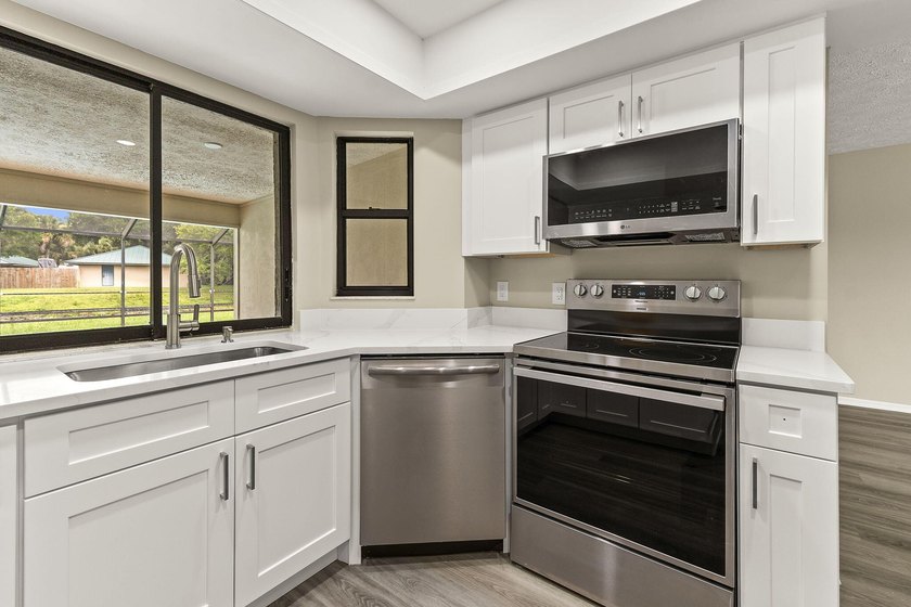 This beautifully remodeled pool home on an over sized lot is - photo 9