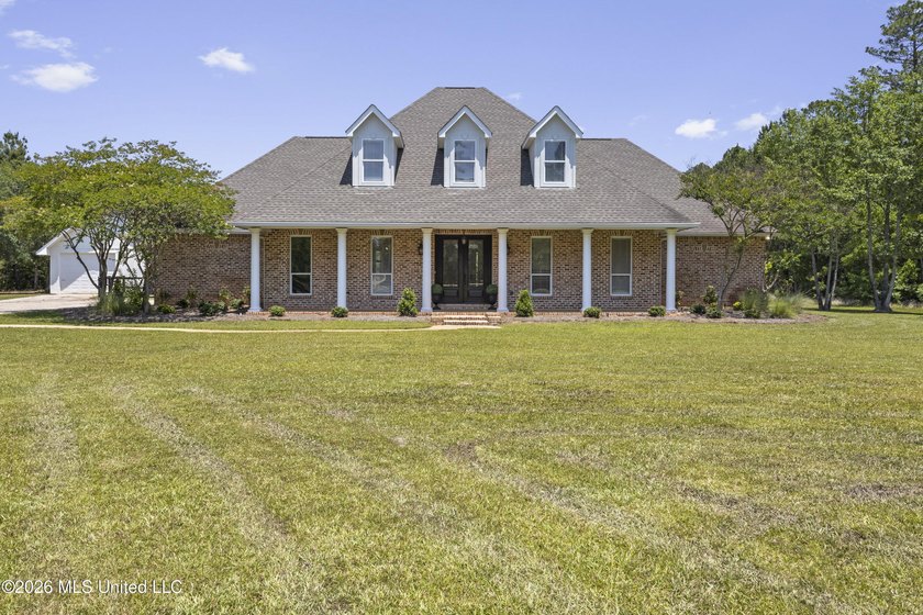 Tucked behind a gated entrance on 5 private acres, this - photo 2