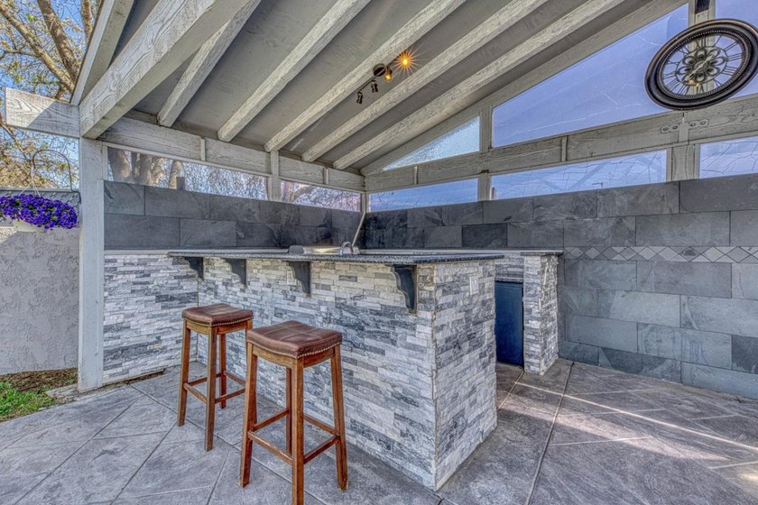 The backyard alone will sell this house. A custom covered - photo 9