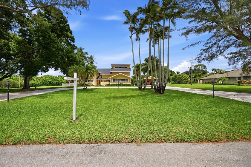 Is there a 4-bedroom home in Palm Beach County with acreage - photo 29