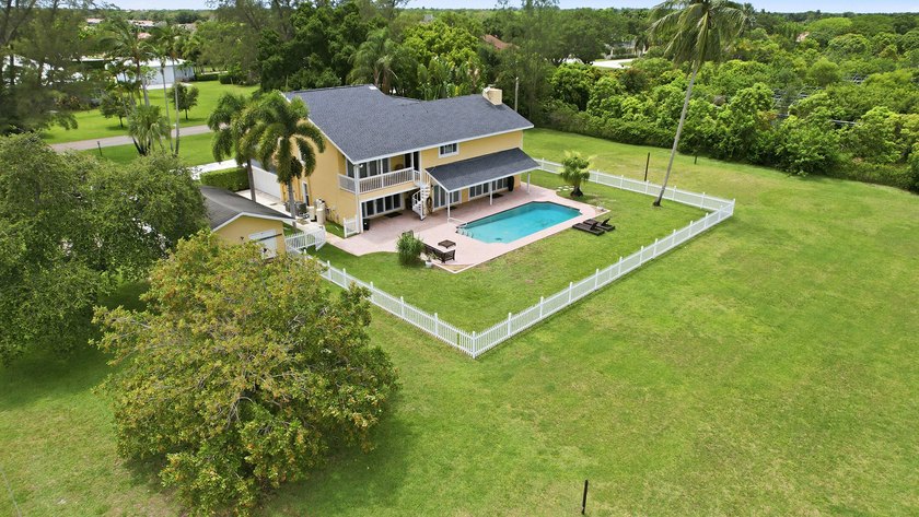 Is there a 4-bedroom home in Palm Beach County with acreage - photo 47
