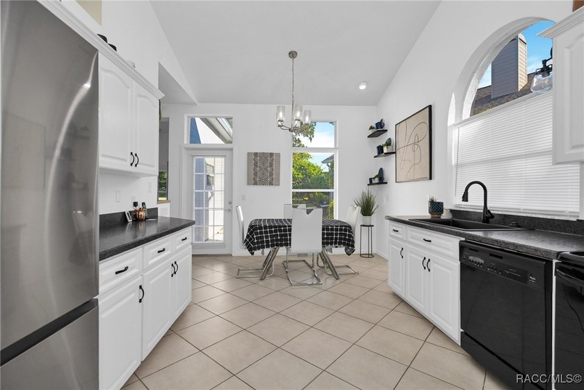 Enter to vaulted ceilings, beautiful bamboo floors in living and - photo 9