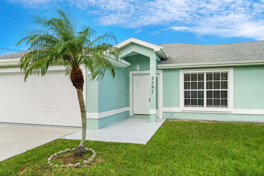 Welcome to 2297 SE Marsh Ave, a 3-bedroom, 2-bath home in a - photo 4