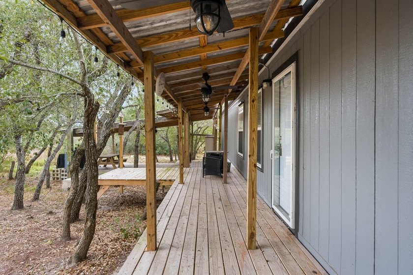 Nestled on wooded land along a quiet road, this newer - photo 3