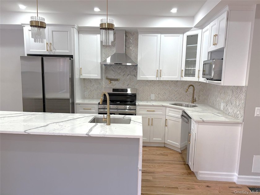 Experience modern luxury in this fully renovated two-family - photo 2