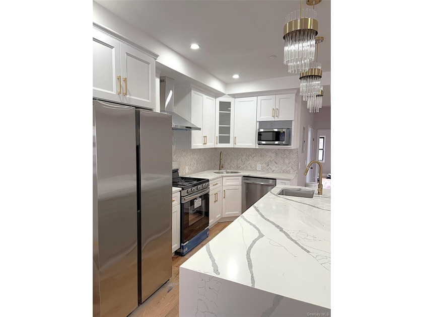 Experience modern luxury in this fully renovated two-family - photo 3