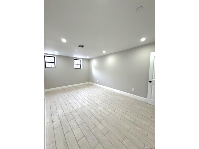 Experience modern luxury in this fully renovated two-family - photo 8