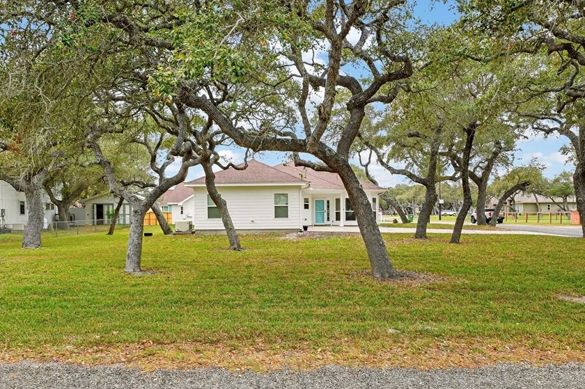 Nestled on a nicely landscaped spacious .66-acre corner lot in - photo 3