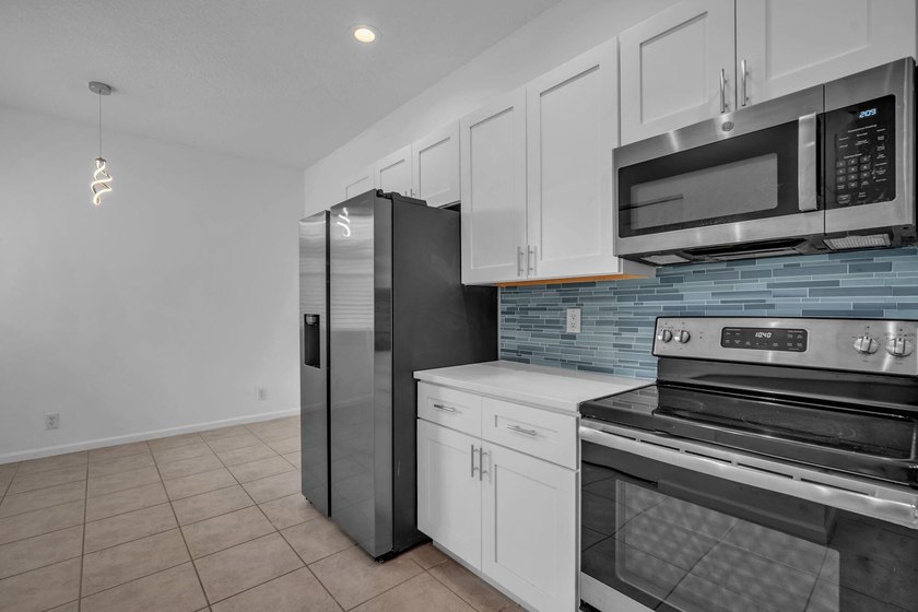 Welcome home to this beautifully updated villa in the highly - photo 5