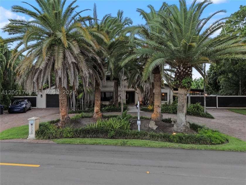 Tucked behind a private, palm-lined entrance in sought-after - photo 2