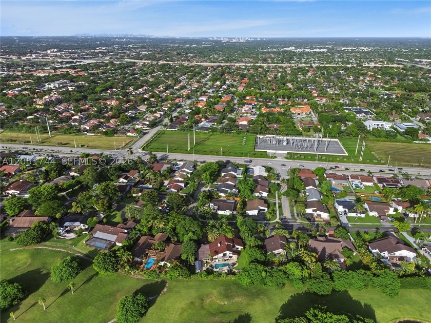 Tucked behind a private, palm-lined entrance in sought-after - photo 4
