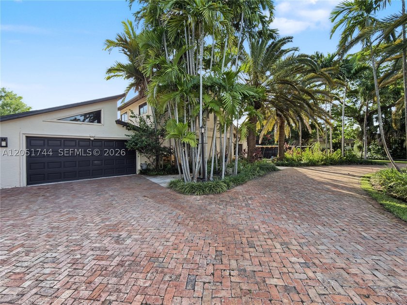 Tucked behind a private, palm-lined entrance in sought-after - photo 5