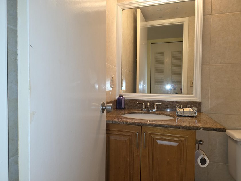 Well-maintained 1-bedroom, 1.5-bath residence featuring granite - photo 18