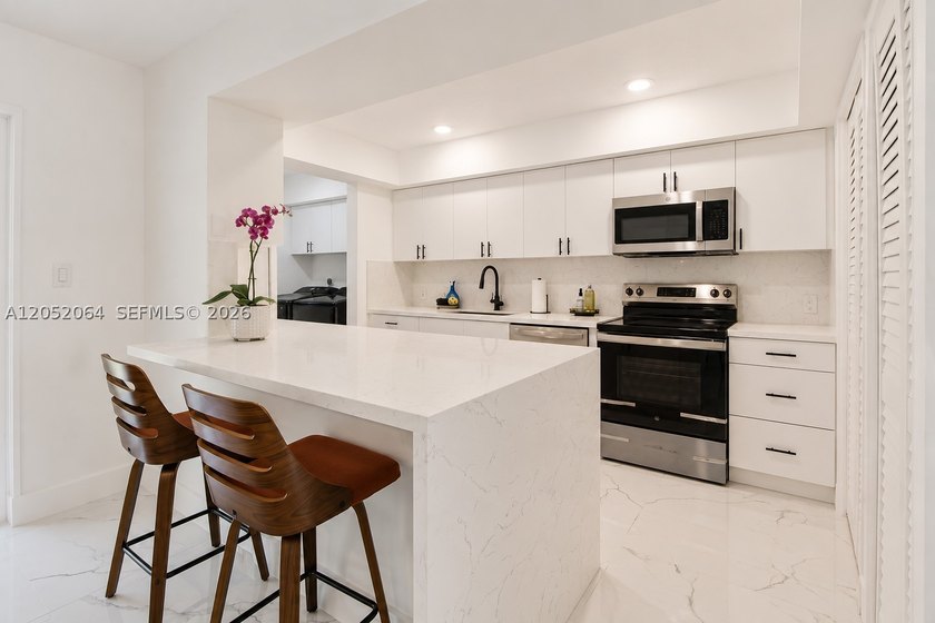 Welcome to this beautifully renovated first-floor condo in the - photo 3