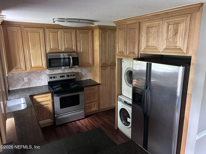 This 950-square-foot, two-bedroom, two-bath end unit sits in the - photo 4