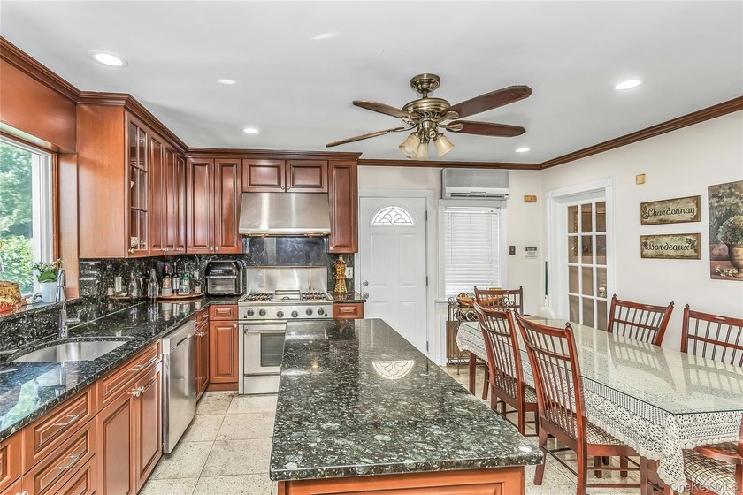 Set on a manicured corner lot in Bayside, this expanded Colonial - photo 11