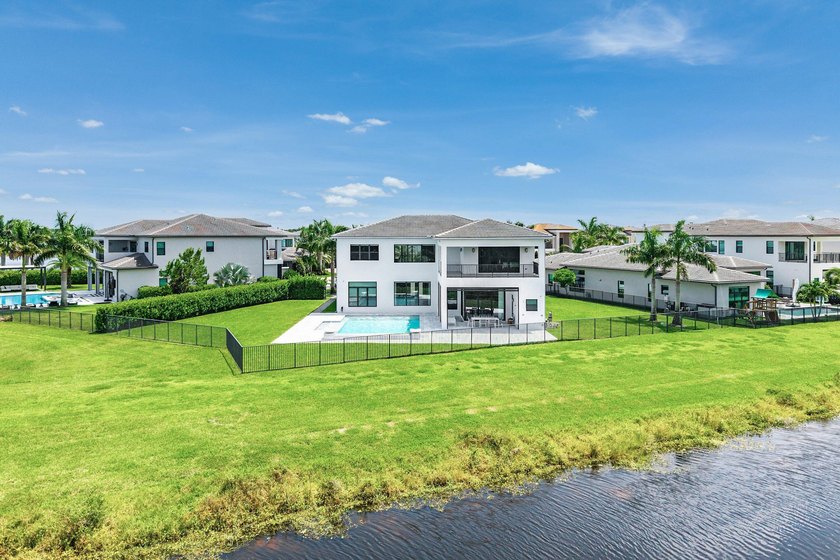 Nestled behind the prestigious gates of Boca Bridges, this - photo 2