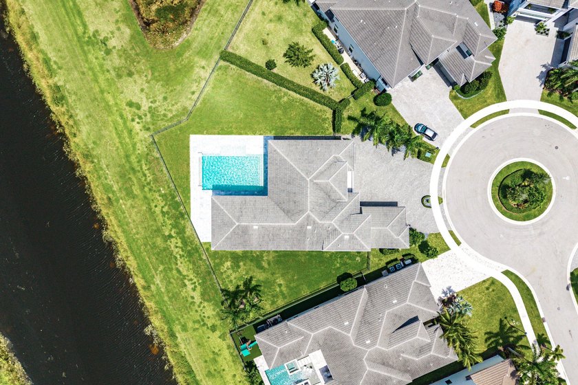 Nestled behind the prestigious gates of Boca Bridges, this - photo 3