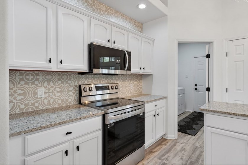This lovely 2051 sq. ft. stucco home sits on a large lot in the - photo 13