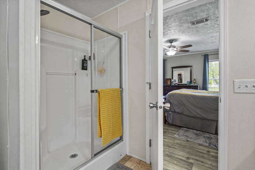 Three-bedroom, two-bathroom, single-story manufactured home with - photo 25