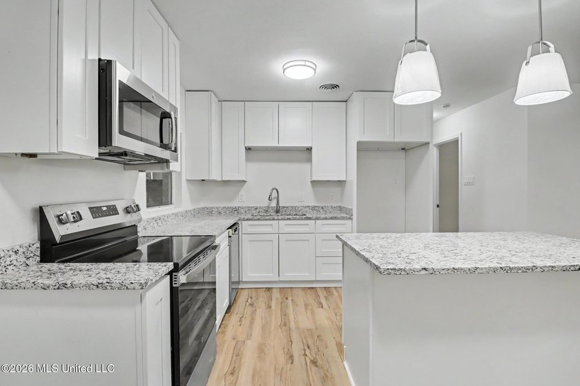 Completely renovated and move-in ready, this stunning 3-bedroom - photo 3