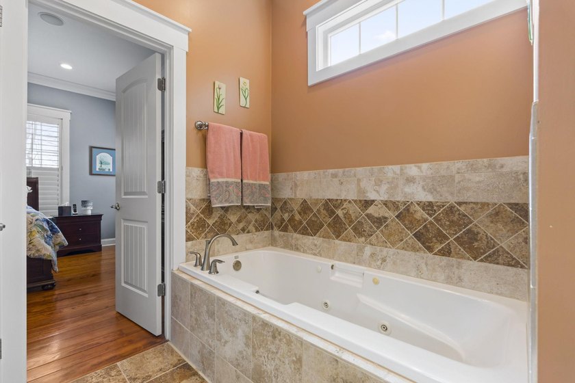 Four-bedroom, three-bathroom, elevated coastal home with a - photo 19