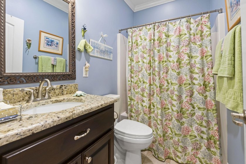 Four-bedroom, three-bathroom, elevated coastal home with a - photo 23