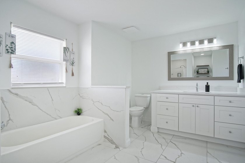 This stunning pool home has it all! Gorgeous plank tile flooring - photo 14