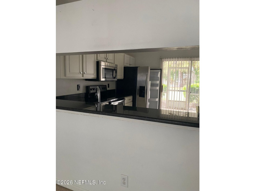 This spacious end-unit condo offers an inviting open floor plan - photo 5