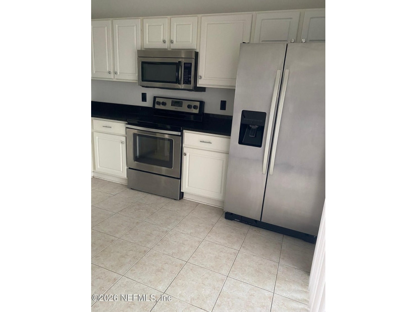 This spacious end-unit condo offers an inviting open floor plan - photo 6