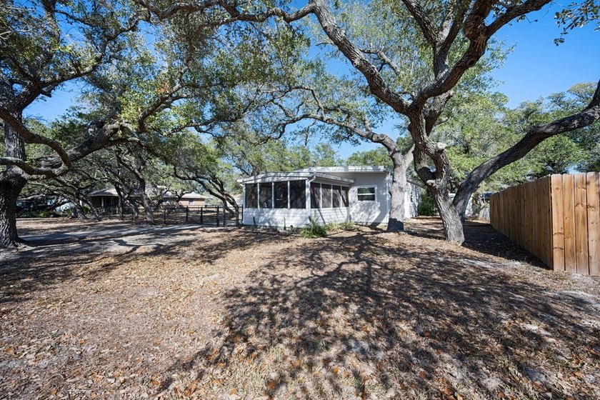 Tucked beneath the shade of towering coastal live oaks, this - photo 2