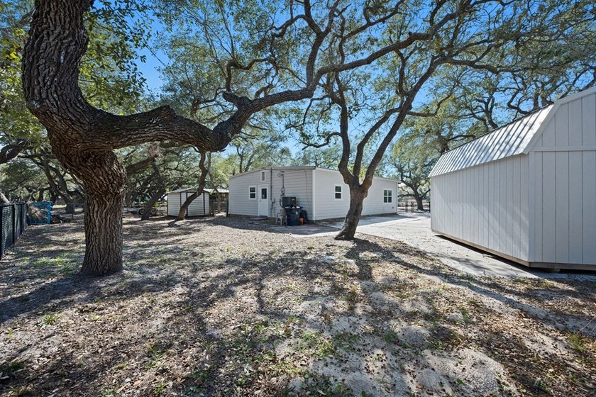 Tucked beneath the shade of towering coastal live oaks, this - photo 4