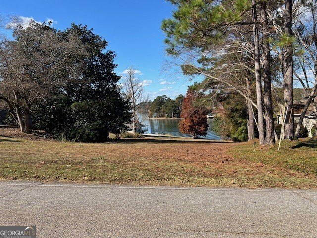 Almost 1 DEEDED acre with approximately 94' WATER FRONTAGE on - photo 4