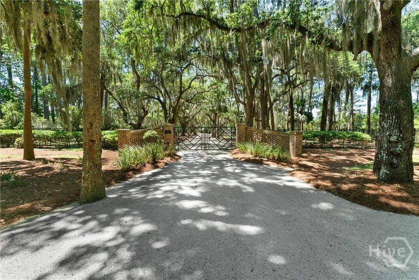 Rare offering Nestled beneath a canopy of ancient oaks draped in - photo 3
