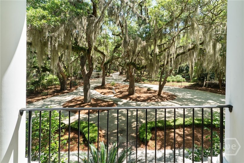 Rare offering Nestled beneath a canopy of ancient oaks draped in - photo 6