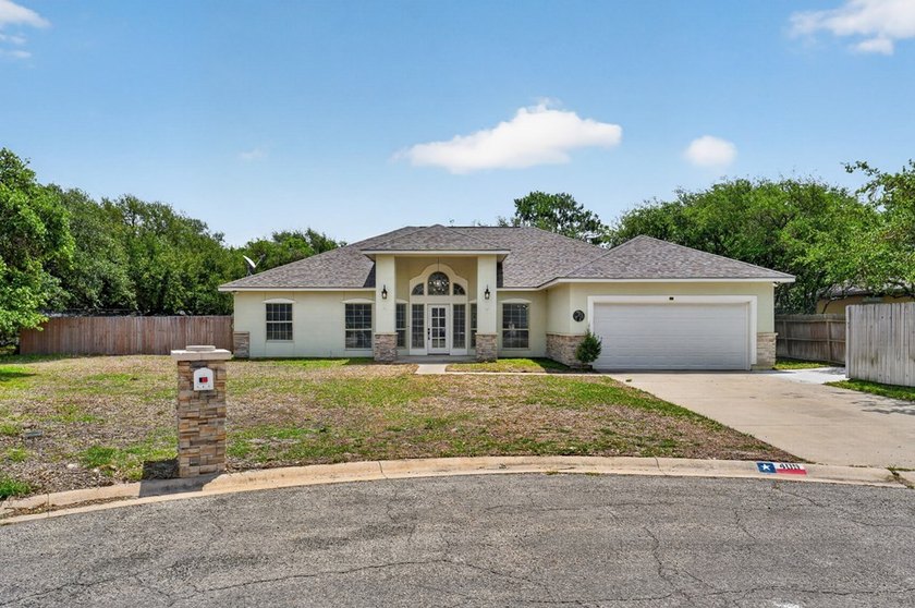 This lovely 2051 sq. ft. stucco home sits on a large lot in the - photo 2