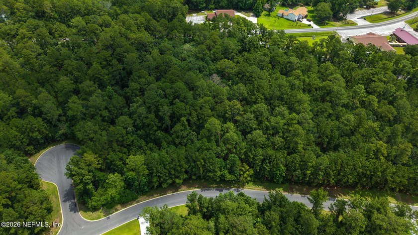 Approximately 1.98-acre wooded homesite located in the gated - photo 3