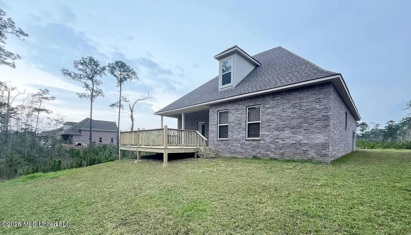 This stunning brick home immediately catches the eye with its - photo 2