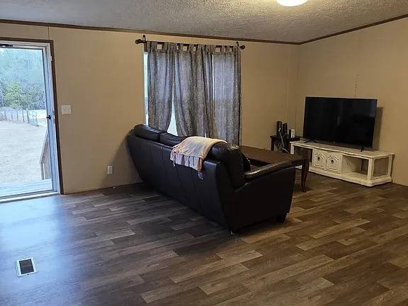 Set on 10 acres, this 4-bedroom, 2-bath home offers space - photo 2