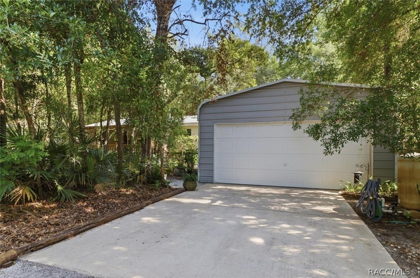 Framed by a canopy of mature trees and lush landscaping, this - photo 2