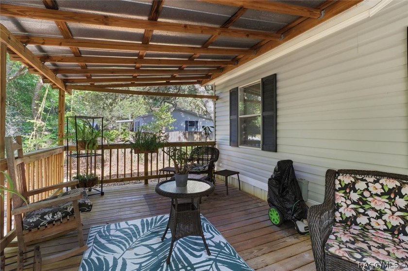 Framed by a canopy of mature trees and lush landscaping, this - photo 6