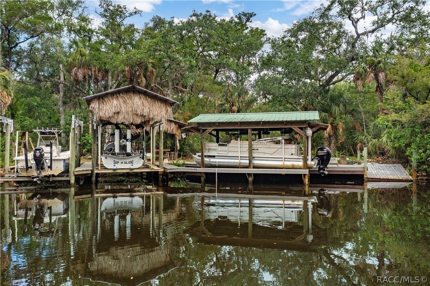 Tucked away on a beautiful wooded 1-acre waterfront lot in the - photo 3