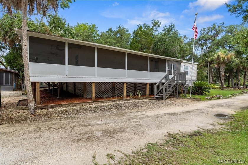 Tucked away on a beautiful wooded 1-acre waterfront lot in the - photo 4