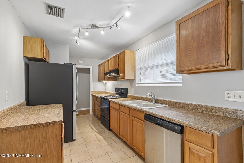As you enter this well maintained home on a quiet street, the - photo 3