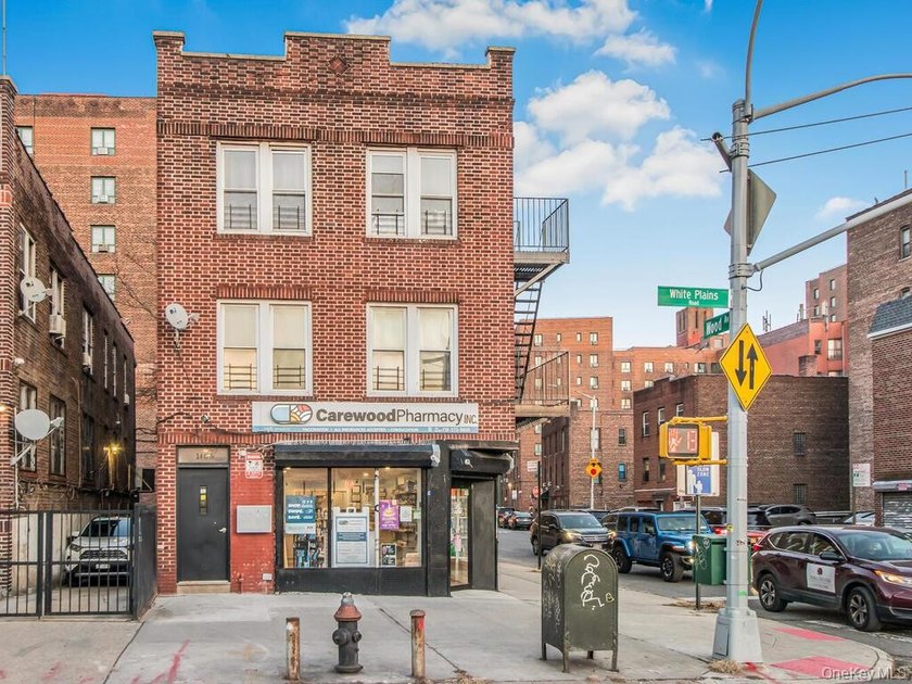 Detached brick mixed-use building with R6 zoning located on busy - photo 2