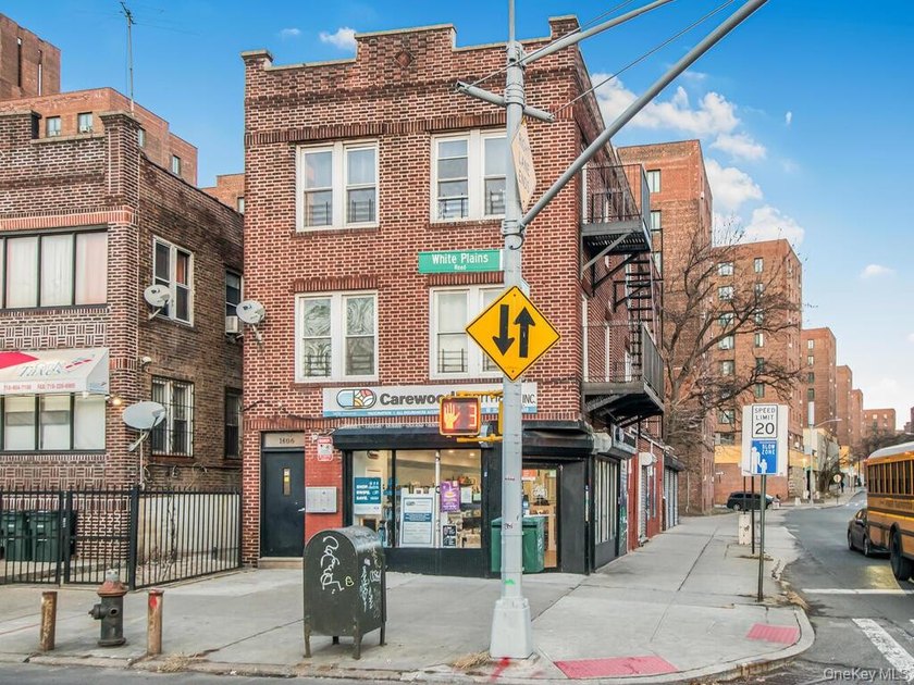 Detached brick mixed-use building with R6 zoning located on busy - photo 3