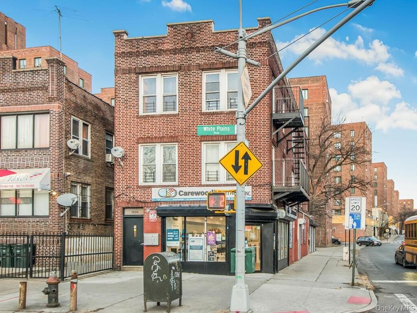 Detached brick mixed-use building with R6 zoning located on busy - photo 4