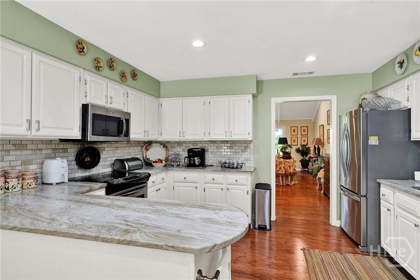 This exceptionally updated, one-level end unit on the lagoon is - photo 9